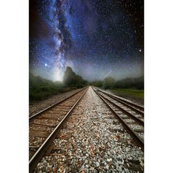 Railroad tracks against clear sky at night