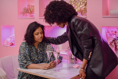 Side view of woman working at table