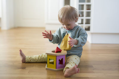 Boy playing with toy blocks at home