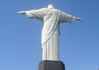 Low angle view of statue against blue sky