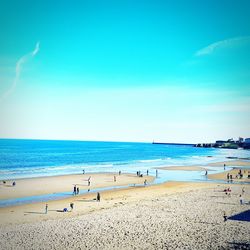 Scenic view of beach against blue sky