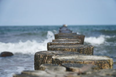 Rocks on beach against sky