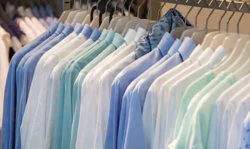 Summer and winter fashion men's shirts on a shelf for winter sales