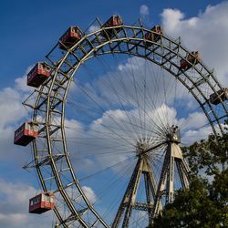 Low angle view of ferris wheel against sky