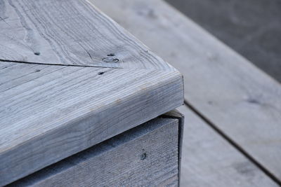 High angle view of wooden bench on table