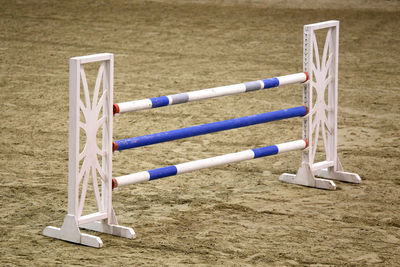 Close-up of deck chairs on sand