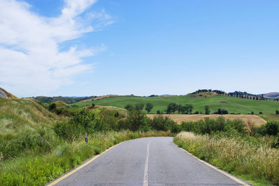 Empty road along landscape