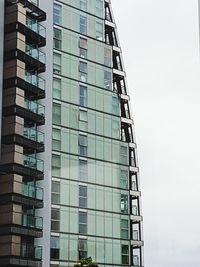 Low angle view of modern office building against sky