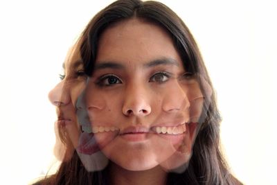 Portrait of young woman against white background
