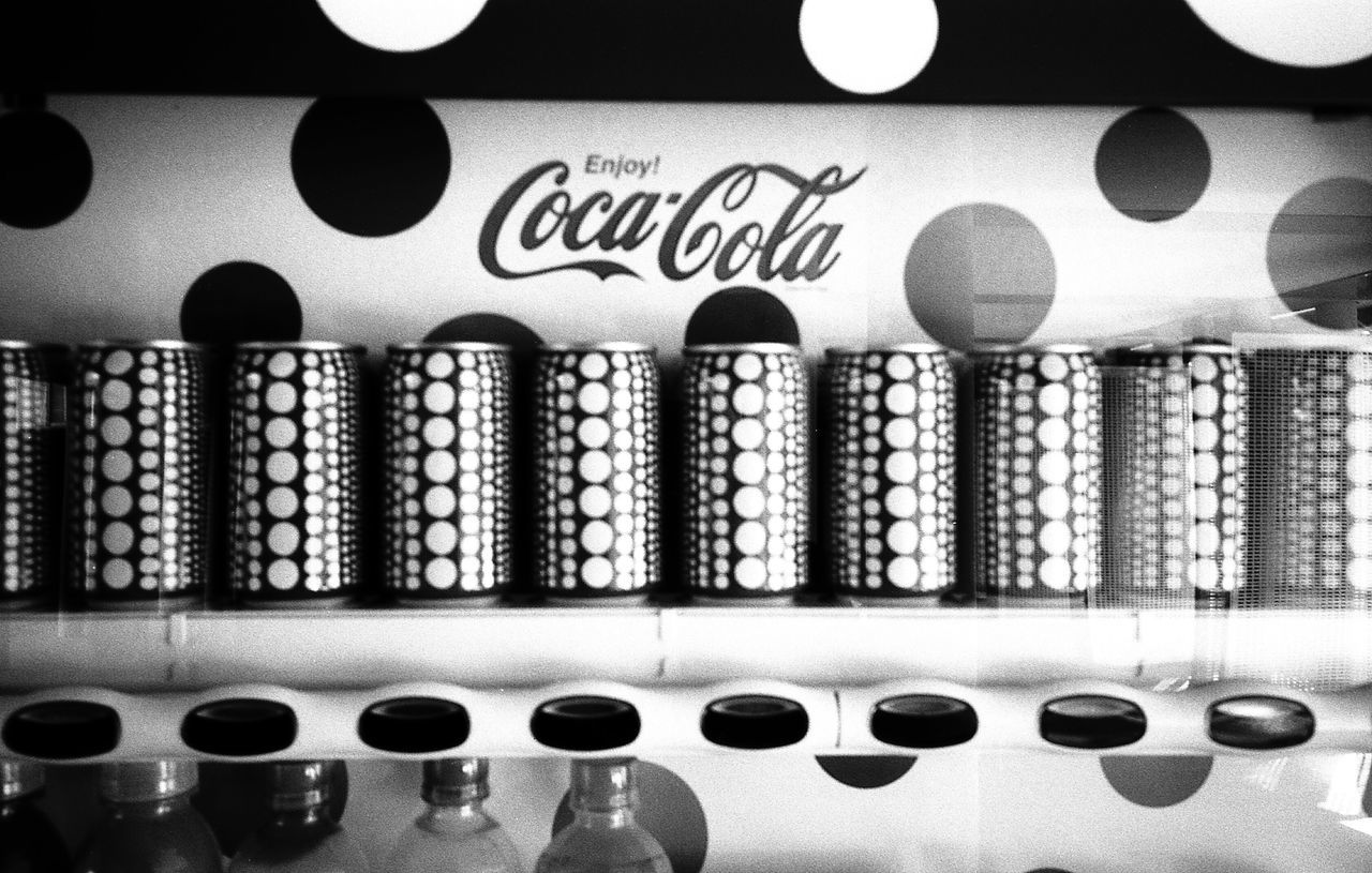 indoors, in a row, large group of objects, no people, bottle, arrangement, variation, close-up, shelf, day