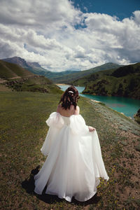 Rear view of woman standing on mountain