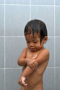 Cute shirtless girl bathing in bathroom