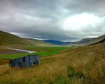 Scenic view of agricultural field against sky