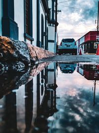 Reflection of buildings in puddle