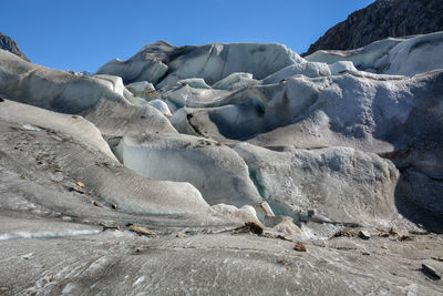 Low angle view of glacier against sky