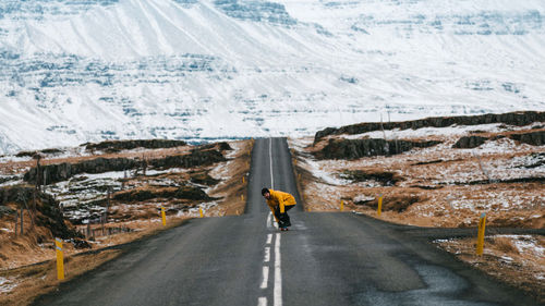 Rear view of man on road in winter