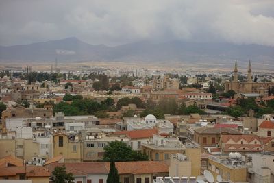 High angle view of houses in town against sky