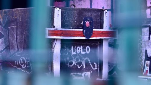 Full frame shot of man with text on window