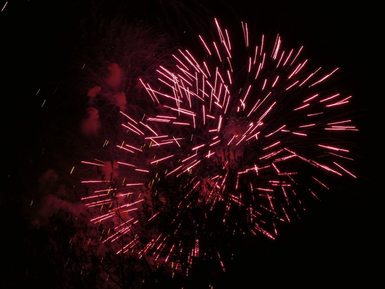 LOW ANGLE VIEW OF FIREWORK DISPLAY