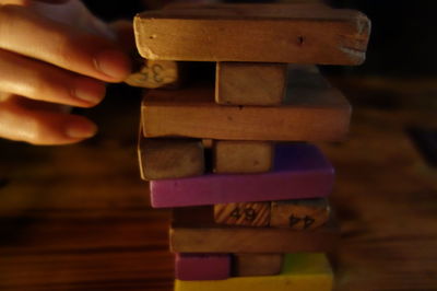 Close-up of hand holding wooden object