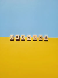 A lot of yellow stickers with words on blue background. concept of  support. stop war in ukraine