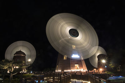 Low angle view of illuminated lights at night