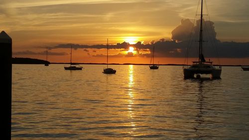 View of boats in calm sea at sunset