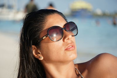 Close-up of woman wearing sunglasses at beach