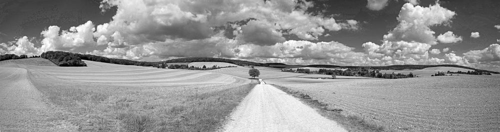 Panoramic shot of land road against sky