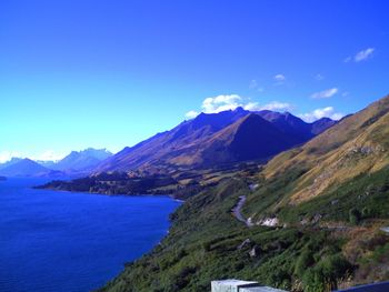 Scenic view of mountains against blue sky