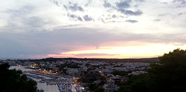 Aerial view of cityscape against sky at sunset
