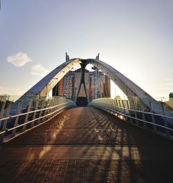 Empty footbridge against sky