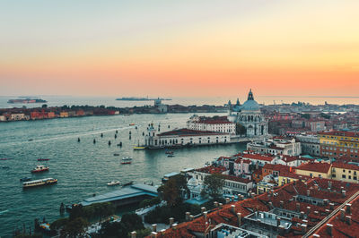 High angle view of buildings in city during sunset