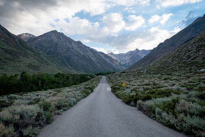 Road amidst mountains against sky