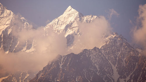 Panoramic view of snowcapped mountains against sky