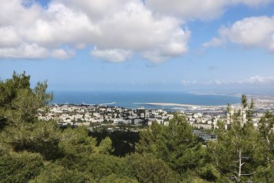 Scenic view of sea by city against sky