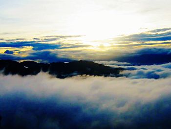 Scenic view of mountains against cloudy sky