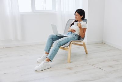 Young woman sitting on floor