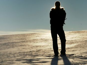 Silhouette of woman standing on beach