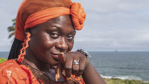 African woman from ghana looking into the camera and pointing finger at the photographer