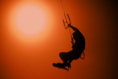 Low angle view of silhouette man against sky during sunset