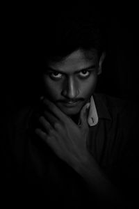 Portrait of young man in darkroom