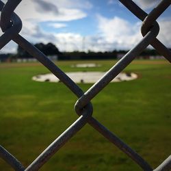 Close-up of chainlink fence on field