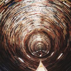 Low angle view of illuminated tunnel against sky at night