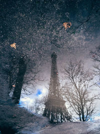 Reflection of eiffel tower on puddle during monsoon