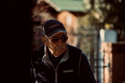 Portrait of man wearing sunglasses standing outdoors