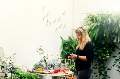 Young woman standing by food on plant