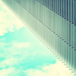 Low angle view of modern building against cloudy sky