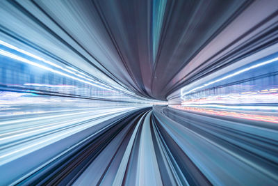 Light trails on illuminated tunnel at night