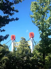 Low angle view of trees against clear blue sky